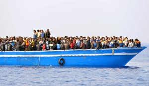 Migrants stranded on a boat, thirty miles off the Libyan coast as they are rescued by Royal Marines. PRESS ASSOCIATION Photo. Picture date: Sunday June 7, 2015. The rescued migrants were taken to the Royal Navy ship where they were searched and processed before being handed over to the Italian authorities. Britain is a country that "doesn't walk on by", David Cameron said as HMS Bulwark undertook another rescue mission off Libya. The Royal Navy warship picked up at least 500 migrants found in four boats in the seas off the north African country. Arriving at the G7 summit in Garmisch-Partenkirchen, Germany, the Prime Minister said the flagship had been deployed because the UK is a "country with a conscience". But he warned that the causes of the mass exodus from Libya must be dealt with, not just the consequences. See PA story DEFENCE Migrants. Photo credit should read: Rowan Griffiths/Daily Mirror/PA Wire